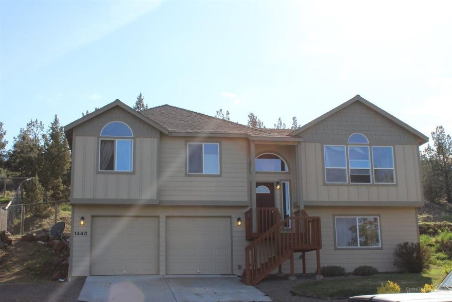 Spacious 4 bedroom 3 bath home on large lot with beautiful Smith Rock views. See through gas fireplace in living room and dining room. Separate living downstairs with family room and 4th bedroom. Private back yard with fire pit area and large patio for entertaining. sloped RV parking, landscaped and fenced yard and deep 2 car garage for extra storage.