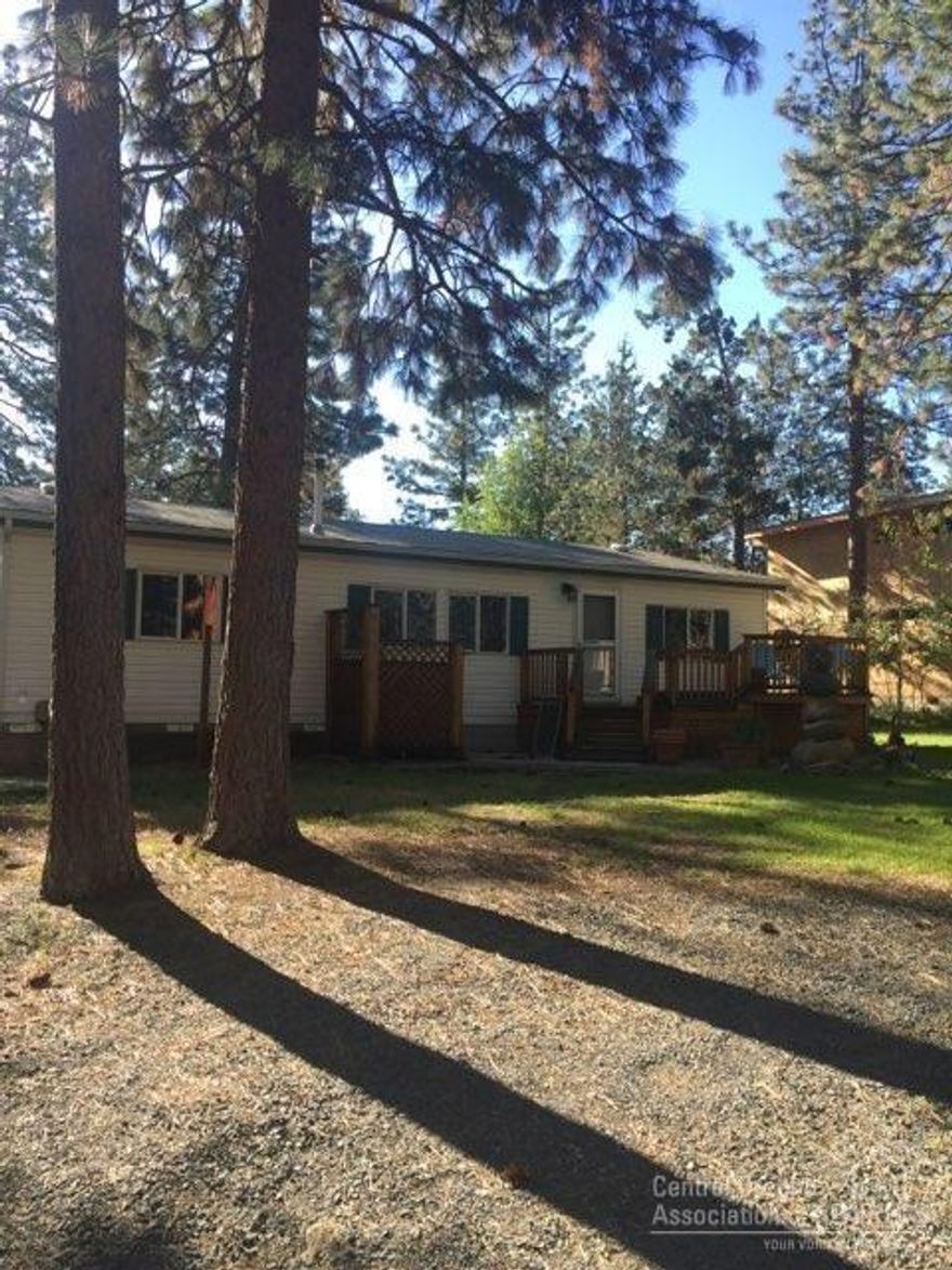 Beautiful almost half acre lot with very live-able manufactured home and two stick built sheds. Right across from the Cedarwood Trailhead and river trail with limited river views through the park area and trees. Entered for comps only.