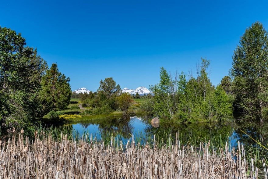 This warm and spacious traditional country home in Tumalo is tucked away in a private grotto opening to the west like a private amphitheater with spectacular views over irrigated pastures to the cascade mountains. There are 48 acres with lawns, gardens, and fields which are meticulously cared for with a large pond including dock and gazebo, as well as a small bunk house and shop/barn. The two level 5,415 sf brick home includes 4 bedrooms, 3 baths, large open kitchen with granite counters and 12' island, living and family rooms, private office, and special, one of a kind wine cellar or he/she cave. Pool table included; llamas and alpacas, optional.