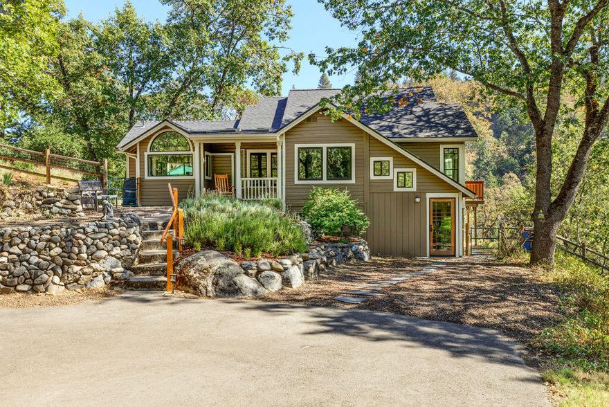 Over an acre in town above Lithia Park, with buildable lot included. Three bedroom two and a half bath in a serene setting with an unbeatable location. Southern exposure provides great light with views of the hills, mountains, and creek. Open living and dining with warm toned bamboo flooring, floor to ceiling, Low UV windows, and many craftsman touches, Spacious kitchen with ample counter space and storage, and cozy breakfast nook. Primary bedroom is located on the main floor with a private deck and en-suite bath with clawfoot tub and shower. Upstairs bedroom is perfect for studio or den with half bath. Versatile downstairs private suite with separate entry for another bedroom, home office or additional living space with full bath. Detached ADU.