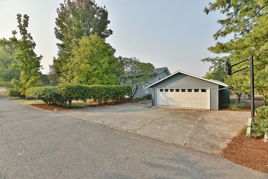 Very unique east Medford home on a large park-like lot.  Imagine living on a quiet and secluded .73 acre lot with the convenience of being right in town, minutes away from shopping and top rated schools! This 3 bed/2 bath, 3490 sq ft home boasts a large family room perfect for entertaining, complemented by expansive, vaulted ceilings and many windows allowing for plenty of natural light. The enormous master suite includes a jetted, soaker tub for the ultimate relaxation. Storage galore with 3 sheds and an extra deep garage/shop combo. This home is also very versatile and offers the space for layout change and/or room additions as well as ADU potential with zoning allowing for 2 additional homes on lot. Call to schedule a showing today-- this is a special property that must be seen to fully appreciate!