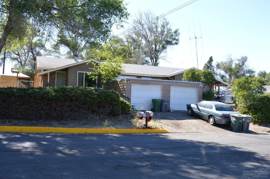 Needs some TLC. Schools within walking distance. Each unit has it's own single car garage.