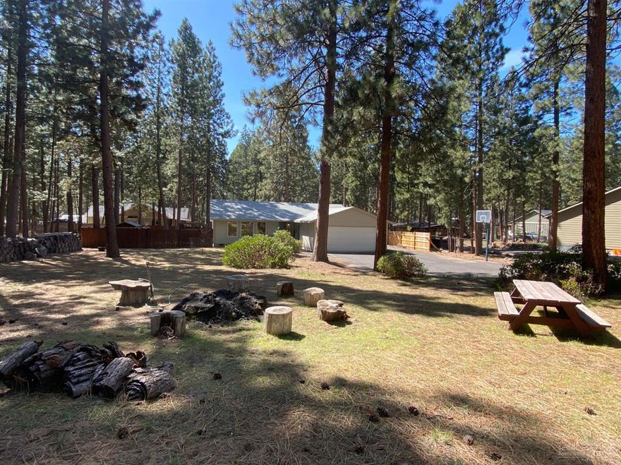 Tucked into the beautiful mature pine treed 0.59 acre lot is this gorgeous single level home with loads of upgrades and updates. Granite counters, stainless steel appliances, undated bathrooms, light fixtures, flooring, trim and more. Ready to go! Nicely fenced back yard, plus a separate fenced in area for the kids with play structure, hot tub sitting under a gorgeous pergola, nice big trex deck, Paved street, and also paved driveway, with RV /Boat parking. Don't miss this beautiful home! Area a nice homes in SW Bend.