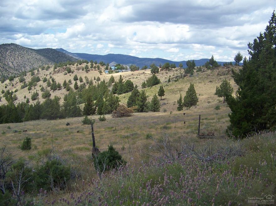 What a view 380 acres of privacy and comforts. Garden and fruit trees. House water is a well that pumps to a 550 gallon cistern. All 380 acres are fenced much of it brand new. Look right down into Deer Creek Valley and the Painted Hills State Park. Covered sun room