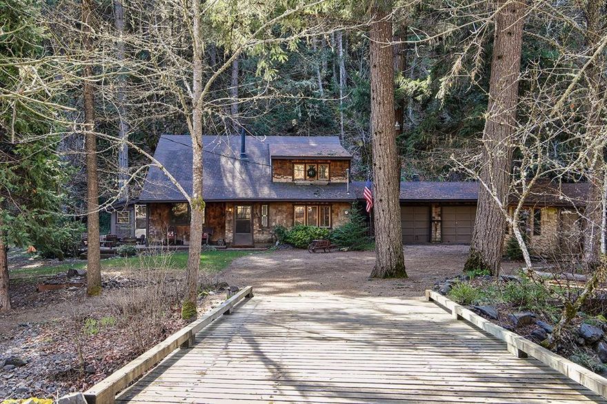 Framed by tall trees and mountains, with a lovely creek meandering through 1.35 wooded acres, you will savor the silence living in this 1936 sq/ft, two bedroom and two bath home with an upstairs loft/office. Extensive use of wood throughout, well-laid out kitchen/dining area adjacent to sliding glass doors that lead to a sunroom, complete with tile floors and skylights above. Two car attached garage also features shed/workshop. BONUS: What enjoyed life as a high-end chicken coop could be converted to a higher and better use. And the best feature is the sound of water bubbling over the rock bed right there in your yard. Adjacent 3.53 acre property is also available to purchase.