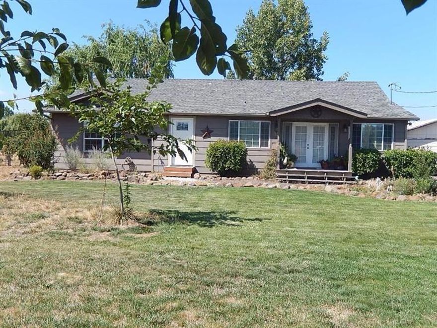 Country/close-in gem. Beautifully updated. Inviting-open great room. Wonderful kitchen w/lots of counters, solid wood cabinets, stainless gas range/oven & refrigerator. Spacious dining area & liv. rm. Huge masterbdrm w/ huge walk-in closet,lovely bath, exterior door to wonderful hot tub, Lagoon,Inground Salt Water Pool, relaxing backyard, deck, gas BBQ. Could be extended family living set-up. Large 2nd bedrm (closest was incorporated into masterbdrm closet but could be changed back) Ceiling fans. Newer roof. New water htr. pool salt system, many more upgrades. Detached Garage/Shop. Barn w/stalls. Pasture. Cost to obtain irrigation when available-approx. $4,000. Chicken coop. Greenhouse. City sewer. Good well. Lots of parking. Country living-w/room for your animals, toys, entertaining in beautiful backyard w/pool. Yet minutes to town, shopping, great schools. This property has so much to offer.