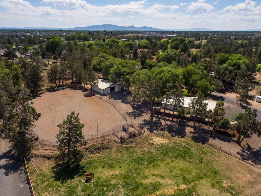 Incredible Equine facility with a 2300 sq ft home on 4.40 acres with 2 acres of irrigation. This charming home has high ceilings, wrap around porch on 3 sides, great room, family room, large master bedroom with walkin closet, 2 sinks, shower and soaking tub. Wonderful kitchen, newer appliances, large utility room attached to mud room with
access to porch. Home is extremely well taken care of. Beautifully landscaped with large shade trees. Great barn with large alley, 5 stall, feed room, large tack room,
property is fenced and crossed fenced with pipe and cable fencing, large roping arena with great footing that is set up with sprinklers for dust control. Great parking area for equipment and horse trailers. Private setting and very close to Redmond off Helmholtz. This is one of a kind and has never been on the market. Shown by Appointment Only.