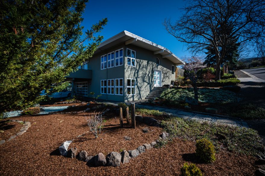 Enjoy a perfect flexible living opportunity with this rare compound located within Ashland city limits. Property consists of two modern homes on separate adjoining tax lots, and a 160 sq ft artist's studio/workshop/home office. Main house is a 3bd, 3bth, 2540 sq ft, 2 car garage on 0.20 acres. Large corner lot with wall of windows, expansive views, modern gas fireplace, en-suite primary bedroom and versatile media room on the lower level. Modern and tasteful finishes throughout. 2nd house (built in 2019) is a 1bd, 1bth, 818 sq ft home with blueprints to add an en-suite primary bedroom. Currently used as an in-law suite, this house would also be perfect as a guest house or additional rental income. Solar panels are located on both the 2nd house and studio. This modern compound is tied together with raised bed gardens, an authentic cedar hot tub and a bocce/corn hole court for perfect pandemic friendly entertaining. Mature landscaping and drip irrigation present throughout.