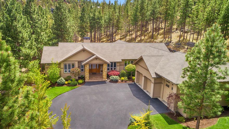 Step into your personal retreat nestled on a generous 1.56-acre plot in NW Bend. This thoughtfully crafted single-level layout boasts meticulous maintenance and superior craftsmanship. As you enter, your gaze is drawn to the panoramic vistas from the back patio and the serene waterfall feature. With ceilings soaring from 10 to 14 feet and expansive floor-to-ceiling windows, the interior basks in gentle, ambient light all day long. The expansive great room centers around a bespoke floor-to-ceiling rock fireplace, creating a warm and welcoming ambiance. The kitchen is a culinary delight with its spacious island, custom clear alder cabinets, stainless steel appliances, and stunning slab counters. Additional spaces including an office, media room, and private gym offer versatility for both work and play. A capacious garage with an RV bay provides ample storage for up to three vehicles. Designed for seamless living and entertaining, this home embraces the natural splendor of Bend, Oregon.