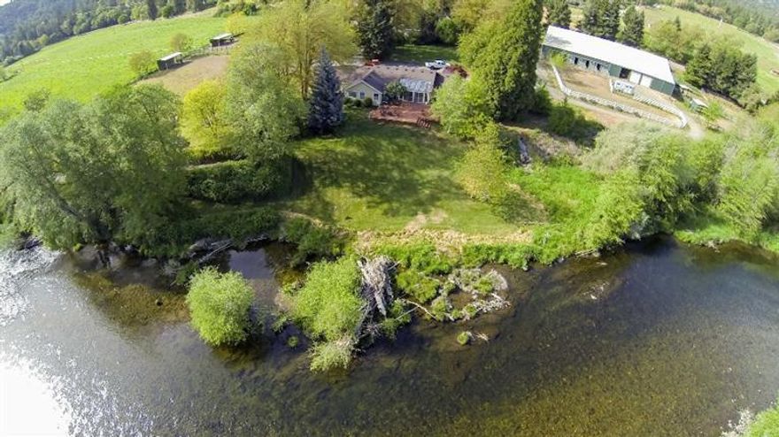 Westwind Farms - a 45 acre equestrian farm on the Applegate River with 2000 ft. of pristine river frontage with exceptional steelhead and trout fishing. Situated just 10 miles from historic Jacksonville, the farm is located in the highly desirable Applegate Valley surrounded by vineyards and wineries. The main home is ranch style and commands a gorgeous view of the river in a park like setting of lush lawns and pathways. There are two separate historic dwellings making the property a great two family setup. The farm is an ideal equestrian property with indoor riding arena, stalls, paddocks, shops, hay/equipment barns. The farm has an abundance of water, 34 acres under irrigation water rights. The entire property is fenced hay fields and cross fenced pastures. There are gorgeous trails and riding paths along the river and around the farm. Excellent vineyard possibilities!