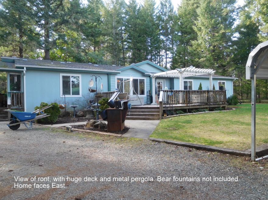 First time on Market in years! Beautiful property with 2 levels. One where home sits in a lightly wooded, serene, private setting. Tremendous home with plenty of space, Triple wide (2007) with formal dining room, living room, kitchen combination. Great open floor plan. Huge master bedroom, and bath. Walk in closet, walk in shower with seats, and dbl. vanities. All bedrooms are above average size. Currently one of the bedrooms has had a wall removed to allow a much larger room for owners crafts and hobby room. Easily converted back to the original 2 bedrooms. Large deck out front with a sturdy pergola attached, looking East towards lower portion of property. Circular driveway, detached garage with shop area, and attached storage and pump house. Property is perfect for livestock, gardening, orchard, or pasture. 2nd culvert type (very old) well on property, in addition to domestic well for home. Wont last long, call for appt. today.