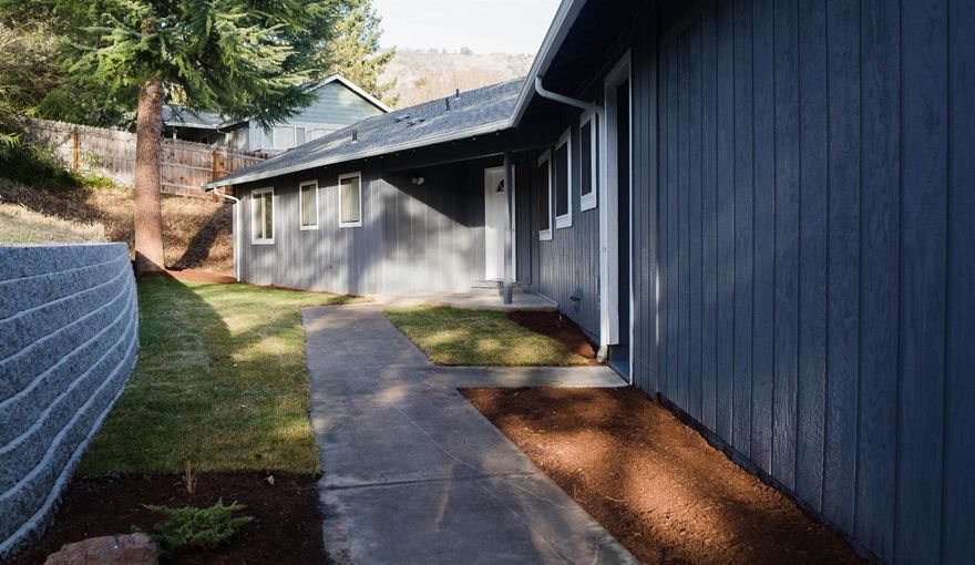 Here we have a beautifully remodeled/updated 3 bedroom 2.5 bathroom East Medford home! Long list of improvements include brand new paved driveway, completely remodeled kitchen including, all new cabinets, brand new stainless steel appliances, tile backsplash & granite countertops! New laminate wood flooring and new carpet throughout, as well as new blinds throughout. The spare bathroom has been fitted with new tile flooring, granite countertops, updated mirrors, light fixtures & accessories. The master bathroom features a walk in tile shower.Step outside onto the new wood deck with metal railing that has the beautiful & peaceful views that this area is known for! All new landscaping includes in ground drip & sprinkler system as well as a new retaining wall. The home has been finished off with all new interior & exterior paint,gutters/downspouts & a new garage door. 1 Year Home Warranty also included! Come out and view this home and you wont be disappointed!