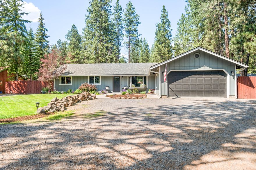 Beautifully remodeled SINGLE LEVEL home located just outside Bend city limits on .89-acre lot. 3 bed/2 bath property includes a 240 SF detached studio—perfect for an office or creative retreat. Recent updates include exterior/interior paint, European white oak flooring, solid surfaces throughout, designer lighting, custom accents, and new windows. The chef's kitchen boasts white cabinetry, quartz countertops, full tile backsplash, expansive island, coffee bar, ss appliances, and butler pantry. The spacious Great Room features a cozy wood stove and barnwood accent wall, with French doors opening to a 1,500 SF paver patio and fully fenced, and landscaped backyard. Enjoy the mature trees, garden beds, greenhouse, and peaceful outdoor living. RV parking, plus two storage sheds and a two-car attached garage. Space for a shop! New roof/septic 2016. Close to schools, trails, and shopping. A rare blend of style, comfort, and Bend charm!