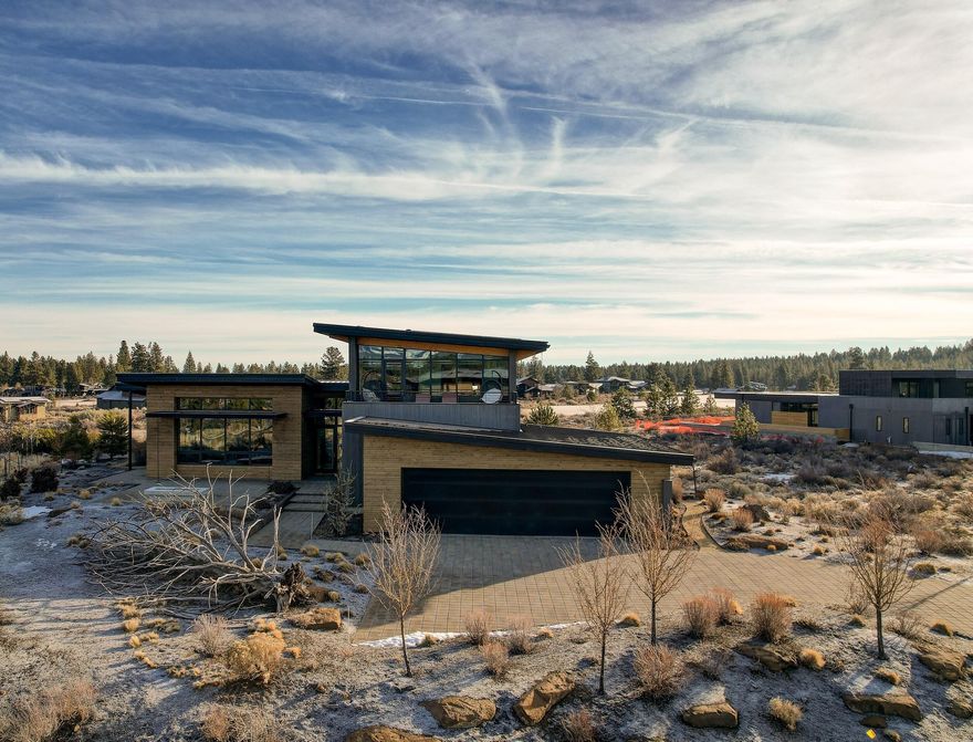 Enjoy breathtaking views of Mt Bachelor, The Three Sisters & Broken Top mountains from this stunning LEED Certified Contemporary home. An entertainer's dream with a gourmet kitchen that includes a 10-piece Miele appliance package including a 6' side-by-side refrigerator/freezer & 2 dishwashers, large center island w/ built-in tabletop, 5' 8'' long stainless steel sink w/ 2 faucets, and a butler's pantry w/ wine refrigerator, kegerator and lots of storage. From there you will find a spacious great room that looks out to a front patio w/ firepit, a tranquil sitting room w/ built-in desk, primary suite, guest room, bathroom and mud/ laundry room all on the main floor. The second level boasts 2 additional bedrooms, bathroom, and open loft/bonus area and roof top deck with full mountain views. Enjoy the backyard space that includes a large patio, built-in BBQ & pizza oven all overlooking the beautiful 15th fairway.