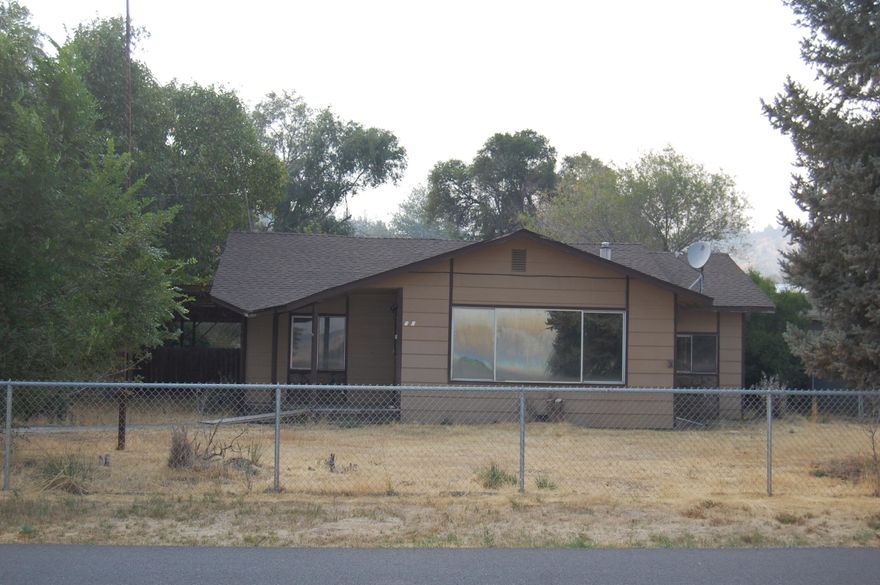 Investors take note! Meadow Lakes Golf Course Views from this .63 acre property. Home has been taken down to studs, offering a clean slate ready for your visions to bring it back to life Open floor plan. 3 bedrooms. 2 baths 1476 SQ Ft plus bonus area for office or flex room. Newer covered cement patio on West side of home, great for entertaining Two private wells. Insulated pump house w/ 2 pressure tanks, septic installed w/leacn field, pumped n 2023. Fenced property, garden area , mature trees & fruit trees, horseshoe pit, underground sprinkler system front and back. Two sm garages, storage areas, root cellar, poultry shed, portable RV cover w/220 power close by. Living room is plumbed for gas. Check with county for zoning options.