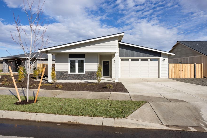 Move-in ready! Recently completed Lot 2 features the Titan floorplan w/ contemporary NW design on a 8,621 sf lot. Single level living with 3 bdrms, 2 baths and 2 car garage. Extensive separation between primary bdrm (w/ walk-in closet & double vanity) & 2 guest bedrooms w/full bath. Entertain in your kitchen w/ SS appliances, pantry, tiled backsplash, soft-close cabinets, extensive slab quartz countertops, large island opening to great room w/ decorative gas burning fireplace. Durable laminate plank flooring thru-out & carpeted bdrms. Utility/laundry room too. Peek-a-boo mtn views. Fenced yard & landscaping w/ sprinklers, RV/boat parking & entrance gate. Upgraded finishes & A/C included! Korbin Meadows is a new community in desirable neighborhood of SW Redmond.
