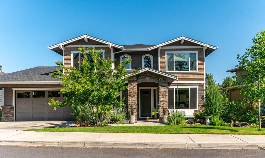 Welcome home to SW Bend and the desirable River Rim neighborhood. This Northwest Craftsman residence blends tried and true design with modern comforts. Once inside, you will discover an open floor plan with good natural light, showcasing fine craftsmanship and high end finishes. The spacious living areas provide ample room for entertaining. The heart of the home is the gourmet chefs kitchen with stainless steel appliances, custom cabinetry, and a large island that invites gatherings. One bedroom and full bath are appointed on the first floor of the home while the generous primary suite and other bedrooms are upstairs. One of the standout features of this home is the oversized, four-car garage that provides plenty of storage and flexibility. Outside, the beautifully landscaped yard and covered patio offer a serene escape for both relaxation and entertaining. Situated in close proximity to shops, schools, parks and the Deschutes River Trail, this is an opportunity not to miss.