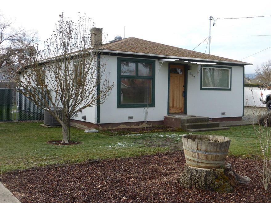 Country setting that's close to town and has city services. This darling cottage style home is move-in ready. Many updates including newer windows, newer kitchen, water heater, paint and central heating and air. The kitchen was totally remodeled a few years ago and has new cabinets, countertops, appliances and flooring. The hall bath has a tub shower. In addition to the two bedrooms, there is a bonus room that can be used as an office, play room or storage. The nice utility room has some cabinets and room for storage. The carport has an attached storage shed. Plus there's lots of room for parking-trucks, RVs or trailers. Also room to build a garage or shop.