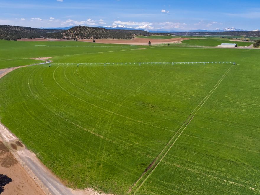 Dry Creek Ranch and Farm is 731 acres with 547 acres of well water rights in the desirable Lower Bridge Valley. The farm has 8 pivots and is currently planted in Alfalfa and grass hay. The property currently operates as a purebred livestock operation with quality infrastructure including:  Office, vet room, covered working facility, pipe corrals with dry lots, loading chute, concrete feed bunks, shops, show barn, hay barns and calving barns. Ranch has a ranch style home 2024 sq ft 3 bedrooms, 2 bathrooms, attached 2 car garage and a cabin. The ranch is less than ½ mile from the middle Deschutes River, borders public land and beautiful Cascade Mountain Views from property. Property is centrally located with easy access to Redmond, Sisters and Bend.
