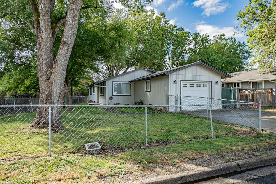 Charming open concept ranch style home situated in a perfect location of Eagle Point. Interior of the home has been completely remodeled with new dual-pane vinyl windows, granite counter tops, kitchen cabinets w/under lighting, stainless-steel hood, carpet, water resistant laminate and tile flooring, porcelain kitchen sink, light fixtures, hardware, electrical switches and outlets, bathroom tiled shower walls, vanities, toilets, doors, paint and newer stainless-steel oven/range and dishwasher. Primary bedroom has a door to the backyard with a new 8x8 deck. Fresh exterior paint and fresh planted shrubbery. HVAC system is forced air with a whole house fan and water heater is gas hookup. Property features chain-link fencing, attached 1 car garage, small fenced space in the backyard perfect for your gardening needs and mature trees for those hot summer days. Close to schools, shopping, parks and much more. This home is a must see!