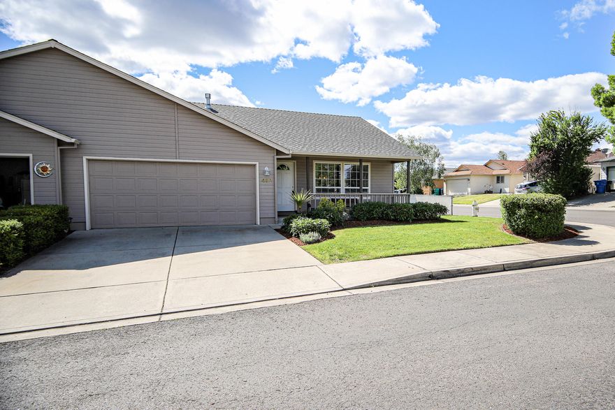 Immaculate inside and out!  Darling zero-lot line home on corner lot has covered front porch with railing.  Vaulted floor plan.  Ceiling fan in great room.  Kitchen offers eating bar, smooth cooktop range/oven, microwave hood and attractive light-wash hickory cabinetry.  Indoor laundry room with extra cabinet storage and drying rod.  Covered back patio and nicely maintained yards front and back.  Attached 2-car garage.