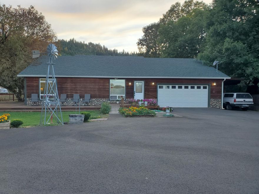 Custom Built 4 bd/2bath home. 
Beautifully landscaped level lot on .54 of an acre. Lrg kitchen w/pantry, slab granite counters & Island. Spilt floorplan w/ lrg primary Bdr on one side.  It has a walk in closet & attached full bathroom w/tub shower combo & double sinks w/door leading to covered deck.  3 Bdrs on the other side.  One of those bdrs also has an attached full bath w/ washer & dryer. Living room has vaulted ceilings & a rock fireplace. Wood deck wraps almost all the way around the house.  Back deck is covered.  Lrg Side deck is graced w/a  grand old Buckeye tree. Garden area. Multiple fruit trees:  Cherry,  Apple, & Plum. Nice  grape arbor. 2 car attached garage.   Carport with attached 10x10 shed  with shelving.  Nice workshop outbuilding and covered wood shed. Sit on your front deck and enjoy expansive views of pasture & mountains w/a seasonal creek. Fire pit area. 
Info deemed reliable, buyer to do their own due diligence.