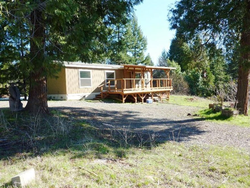 Over 80 acres, beautifully treed with gated access and adjacent to BLM land and large tract timber land. South facing with high end double walled greenhouse and approx. 10,000sf fenced and plumbed garden area. Extensive water system, approx. 7.5gpm well and several artesian springs per Seller. Private location with mountain views, double wide manufactured home w/lg covered wood deck, ponds, shop, three (3) separate power meters with capabilities of 600 amp service & two (2) 1400 gallon cisterns. All personal property included in the sale in AS/IS condition.