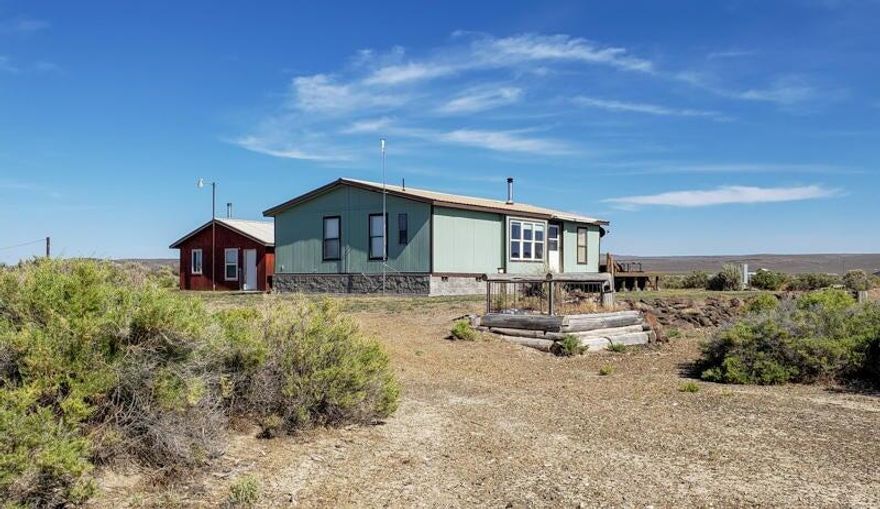 Discover 20 acres of peaceful privacy with this 3-bed, 2-bath home, featuring vaulted ceilings, abundant natural light, central heat plus a wood stove for year-round comfort. Stay cool with good insulation and an AC window unit. The primary suite, separate from other bedrooms, offers a double vanity and walk-in closet. Enjoy a large deck overlooking a seasonal pond, plus a metal roof on the home and garage. A shaded carport keeps extra vehicles protected. The oversized shop/garage, complete with a workbench and wired for 220 is perfect for hobbies and all your recreational gear. Nearby attractions include hot springs, golfing, caves, hunting, fishing, hiking, and unique geological wonders like Fort Rock, Sand Dunes, Volcanic Cones, Lost Forest & Crack in the Ground. Your perfect desert retreat awaits!