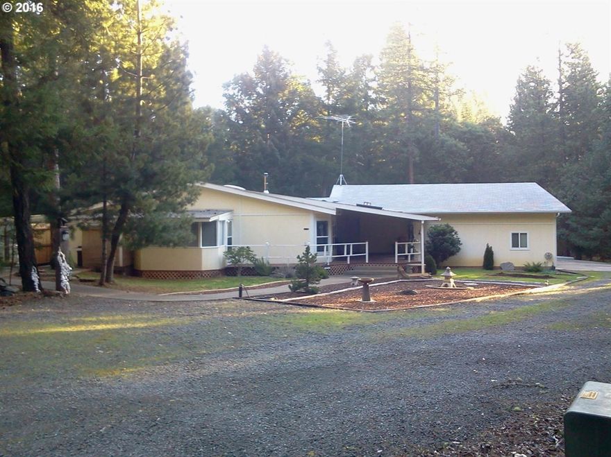 Beautiful, secluded, park-like setting on 2.5 acres. 2140 sq.ft. home with newly remodeled dining room, master bath, and guest bath.Huge 1760 sq ft.attached shop, and 3 additional outbuildings. Wood stove & heat pump. large master bath with soaking tub. Ceiling fans (4) and lots of storage. floors are laminate, tile, and carpet. Walk-in closet in master bedroom.