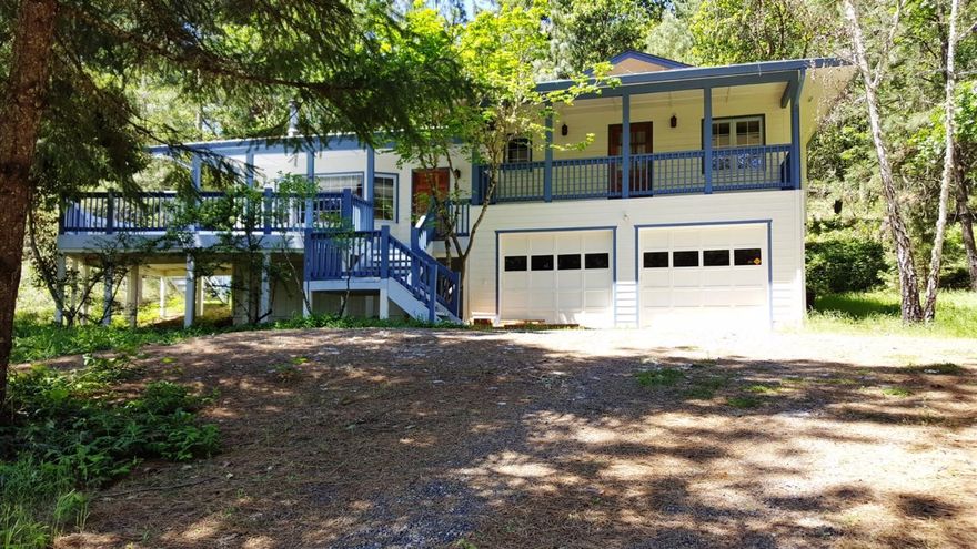 Vacation home, hardly used is now ready for someone else to enjoy to live in or have as a second home. This home has been very well maintained with new paint on the house, deck and sits in a beautiful country setting. House is low maintenance outside with natural settings with trees, private circular driveway and parking on the right of house. Open vaulted living room with wood beams, views out the windows, newer heat pump, den and downstairs is another bedroom being used as a shop with a half bath. Cozy and quiet at the end of Timber Lane you will enjoy country living just minutes from Grants Pass, Merlin, the Rogue River and more. Low taxes. Enjoy this pristine home that is ready. Home can come furnished as is if you want the furniture etc that is in the home. All information deemed accurate but not verified or guaranteed. Buyer to perform all their own due diligence.