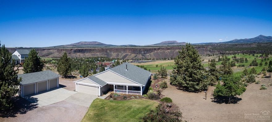 LOCATION, LOCATION at the entrance of Crooked River Ranch, overlooking the 18-hole golf course, surrounding buttes, & green farmland across the Crooked River Canyon. Truly a postcard setting, seen through walls of windows or from the wrap-around covered porch w/hot tub. Hardwood floors, pine tongue & groove vaulted ceilings & a beautiful stone hearth, ready for your choice of secondary heat speak to the comforts of home. In addition to attached 2-car garage, is a 3-car garage-shop. You won't be disappointed