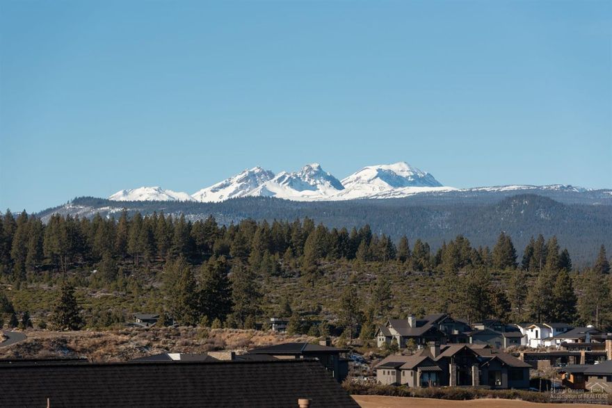 This stunning premium view lot with Cascade Mountain and golf course views is conveniently located on The Rim near the Tetherow clubhouse, fitness center, pool and three restaurants. Main floor master suite with fabulous bath; gourmet kitchen opens to impressive great room with large covered balcony that extends over to master suite. Main floor boasts den and 2 en suite bedrooms. Two additional suites and bonus room on lower level with patio. Fantastic location with Mt Bachelor and Phil's Trail at your door!