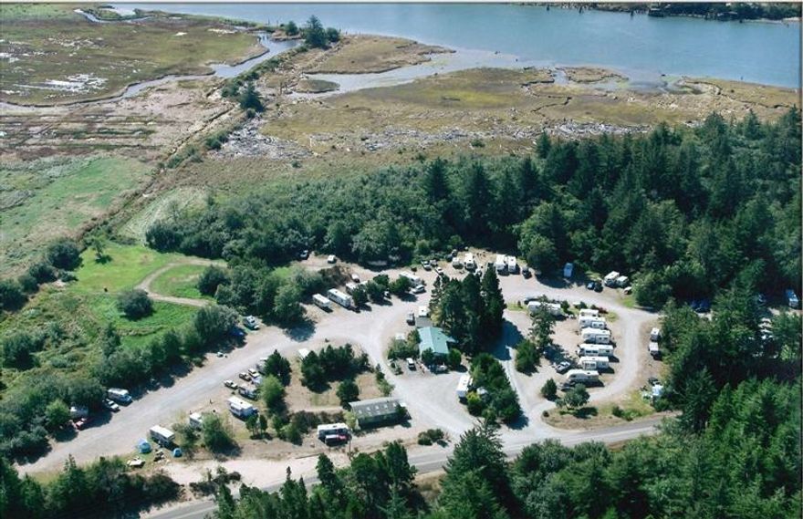 A DIAMOND IN THE ROUGH! Lot's of opportunity on this 8+ acre parcel, most recently a RV park and campground. Area for tent camping, rv/trailer spaces, building for showers and bathroom facilities and a mobile home for office/landlord living space. Conveniently located with Hwy 101 visibility just north of Bandon.