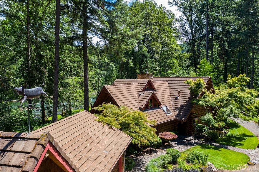 Majestic McKenzie River Estate featuring an unparalleled setting with over 400' of McKenzie River frontage. Authentic log home with gated entrance boasting privacy and serenity. Beautifully manicured lush landscaping and large private pond with casting dock in front of home allowing 360 degrees of water views. East Wing provides main living quarters with a fully updated gourmet kitchen featuring leathered granite countertops, stainless steel appliances, copper sink and thoughtful design. Custom McKenzie River rock wood-burning fireplace in great room and custom woodwork throughout. West wing has been fully updated and provides private guest bedrooms, including small kitchenette, full bath, offices and media room. Property also includes detached boathouse for rafts/kayaks, professional dog kennel, boat access, large deck with hot tub & built-in BBQ and is fully irrigated with water rights.