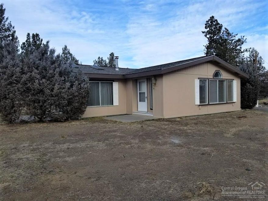 What a buy!! Where else can you find acreage with wonderful mt. views, 5.6 acreages, 1800 sq ft heated & insulated shop plus office area, convenient Tumalo location. 2.5 acres Tumalo irrigation, shared well, plus 3 bed/2 bath In addition there are 2 pasture areas plus pond. Shop/home have certified wood stoves. Home has a brand new roof and fresh exterior paint. Tumalo/Redmond schools. Great area for hobby farm. Build your dream home while living in the current home.
