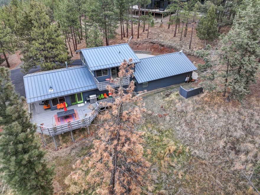 Discover tranquility and a serene escape into nature on this 1.27-acre property w/ Cascade Mountain views. As you step inside, oversized picture windows flood the living spaces with natural light, capturing the stunning surroundings. The great room floor plan creates a sense of spaciousness, enhanced by wide plank hardwood floors, a modern fireplace & elegant lighting fixtures. Culinary enthusiasts will appreciate the well-appointed kitchen featuring a 5-burner cooktop and tile back splash. The three patio spaces invite both entertaining or a quiet evening. The oversized two-car garage is perfect for all your recreational toys, and there is a dedicated RV parking with hookups. This home is more than just a residence; it's a lifestyle. Impeccably maintained and offering private, low-maintenance living, you're just minutes away from town, trails, and all that Central Oregon has to offer. Don't miss the opportunity to make this your haven where serenity and sophistication converge.