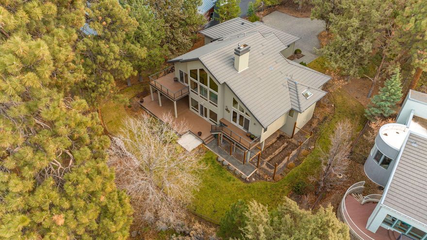 Deschutes River front home! Nearly 1 acre of serene riverfront living with private river access & peaceful views of the iconic Deschutes River from nearly every room. This property is fenced and gated with mature trees surrounding the home for ultimate privacy, a true one of a kind riverfront home. Three of the four bedrooms include their own attached bathroom with a living room on the main level plus a family room on the lower level. With an additional half bathroom, cold storage & large laundry room. The large vaulted ceilings allow tons of natural light from the floor to ceiling windows. Multiple private TimberTech finished decks, 3 car garage with one heated bay, electric car hookup & workbench. Centrally located within walking distance to downtown, river trails & parks. Plus, private access to the river through your own back gate. Come discover the meaning of living the Bend Life.