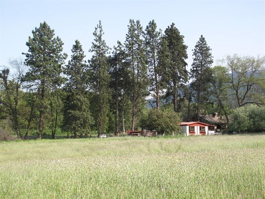 Bring your livestock! Property is great for horses, cattle, grazing or run it as a hay ranch. 37.01 acres of highly productive, irrigated pasture and hay ground. A cozy Redman double-wide holds the home site and is quite livable. 3000 square foot sided barn with covered working chute and corrals are a very practical necessity. A year-around spring fed pond compliments the land.