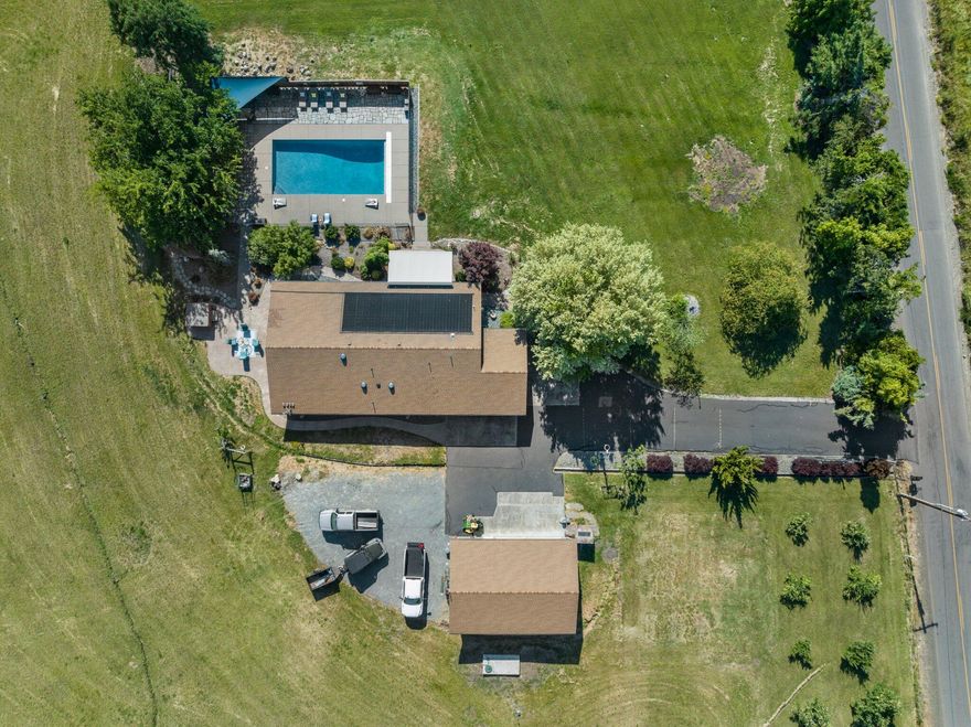 Welcome to 630 E Valley View Rd. Ashland a serene 9.97-acre oasis with stunning panoramic views and endless possibilities. This 1,776 sqft home offers 3 bedrooms and 2 full baths, blending modern amenities with rustic charm. The open floor plan with hardwood floors, an abundance of natural light, and a gourmet kitchen featuring stainless steel appliances and a farmhouse sink. Step outside to your private custom pool with solar heating, perfect for relaxing or entertaining on the spacious patio. The property also includes irrigation rights from TID, making the beautiful pastures of green grass and mature trees ideal for agriculture or recreation. A paved and gated driveway leads to a detached shop and storage area, offering ample space for hobbies and projects. With EFU zoning and the peaceful backdrop of year-round natural beauty, this property combines the tranquility of rural living with the convenience of being just minutes from downtown Ashland. The Oregon Dream awaits you!