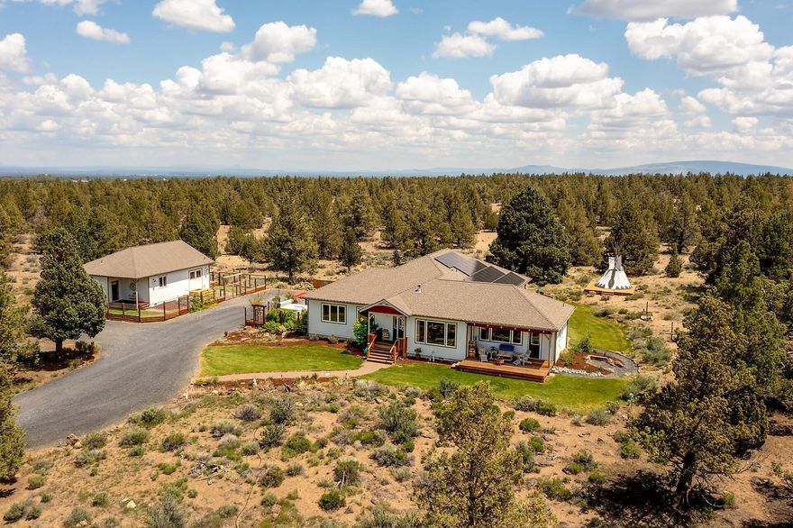 One Level Home w/ Potential 1,000 sq. ft.  ADU is located just minutes from everything Bend has to offer! Beautiful Cascade Mountain Views, Privacy & Starry Nights provide a peaceful retreat for family & guests. Just 9 miles to St Charles Medical, 10 miles to Downtown Bend & 30 miles to Mt Bachelor Ski Resort, your front door is your gateway to Adventure, Fine Restaurants & the beauty of Central Oregon! 3 Bed/2 Bath Home features high end finishes, pristine hardwood floors, soapstone counters, tiled bathrooms, kitchen w/ custom cabinets, gas cooking, & large island opening to a great room w/ vaulted ceiling, fireplace & mountain views! Primary Bedroom w/ large bathroom, walk-in closet. Located on 9+ acres at the end of a cul-de-sac that borders county property, you will enjoy this private & peaceful setting.  The property includes a detached & beautifully finished space, or potential ADU w/ over 1,000 sq. ft., fireplace & full bath. Owned Solar Panels & EV Charging Station included.