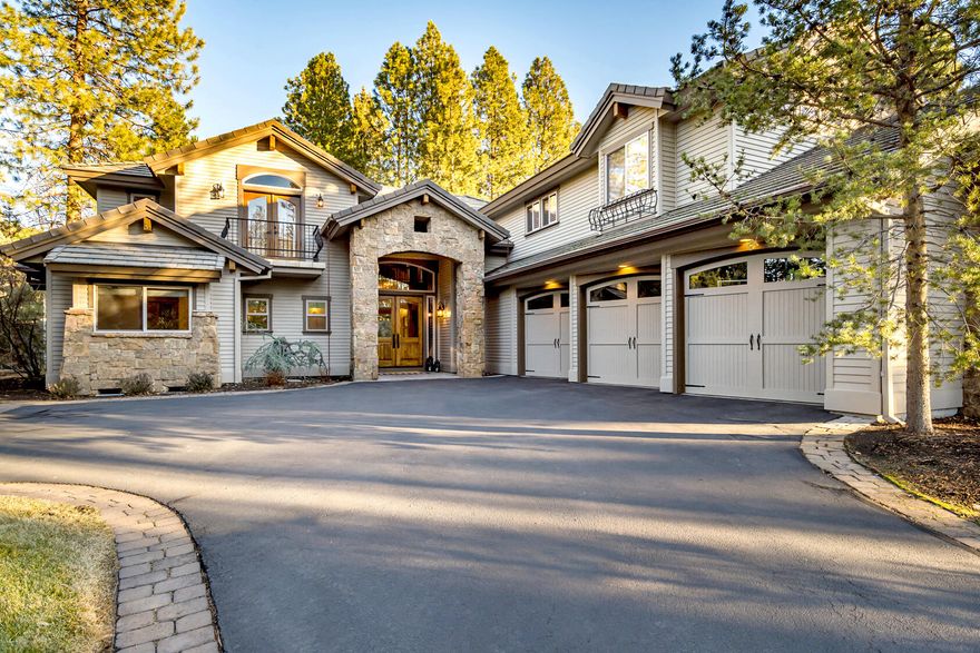 This thoughtfully designed home on Tam McArthur Loop in Broken Top features elegant finishes, superior craftsmanship, and attention to detail. The great room offers a warm and open environment, with a floor-to-ceiling stone fireplace and a wall of windows that brings the outside in. The dining area flows seamlessly into a chef's-grade kitchen and charming wine room with a Dutch door, and original brick reclaimed from The Old Mill. The main level also includes a private guest suite, custom-crafted office, flex space, and 3 car garage. Upstairs, you'll find a bonus room with wet bar, two additional bedrooms, and the primary suite, featuring a quaint balcony and soaking tub. The covered paver patio with private, forested setting, is ideal for outdoor entertaining or gathering around the fire pit. Experience refined living in this timeless home and explore the exclusive amenities offered by the award-winning Broken Top golf course and community.