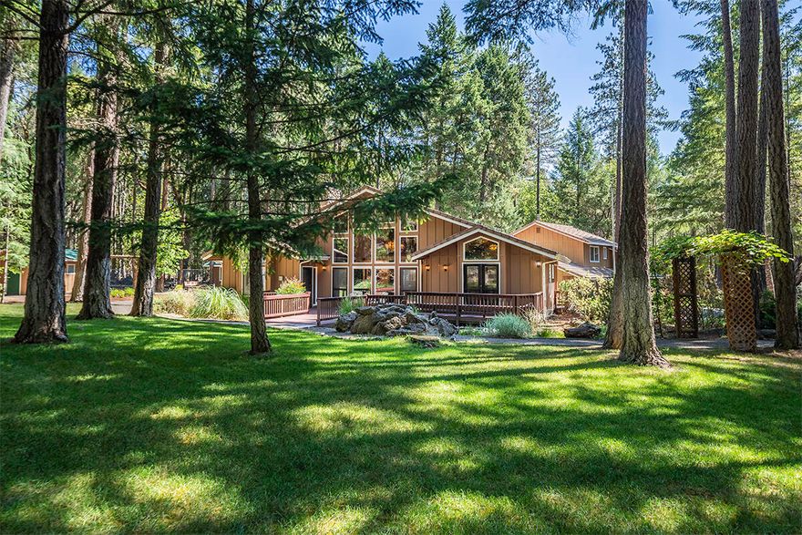 A very impressive 2 Bed, 2 Bath 2591 Sq Ft Home with an Open Loft Library (includes a large storage closet), a separate 1 bedroom 1 bath Independent Suite (above the garage) , attractive large decks surrounding the home to enjoy the beautifully landscaped property, and soothing sounds of the waterfall feature is ready for its' new Owners to come enjoy! The home and property has been used, in the past, for retreats & has an additional, attached, large media room. A very important special feature in this home that is hard to come by with tranquil country living - Super High Speed Fiber Optic Cable from Hunter Communications. Need to work from home? No problem! There are so many amenities they have to be listed separately! The foyer looks to the living room and breakfast nook with the formal dining room to the left. The open airy kitchen with beautiful oak custom cabinetry, a large pantry, huge laundry room, and storage galore, leads to an exterior door with an electric wheelchair access.