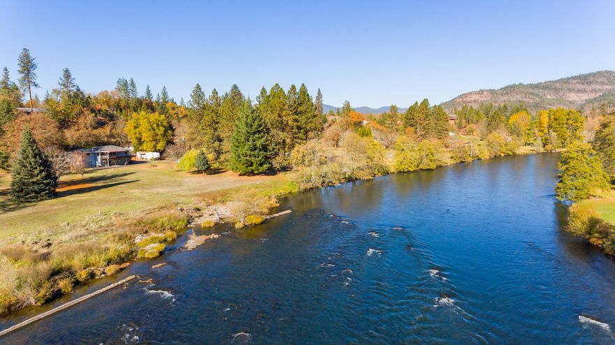 Such a special home and property offering a comprehensive package that's nearly impossible to find on the Rogue River! 1.41 irrigated acres on a beautiful section of the river with a large, usable yard and low bank river access; a turn-key home with two attached garages and a detached shop, plus RV parking with power and water hookups. Recently remodeled with a custom kitchen and baths, flooring throughout, interior and exterior paint, fixtures and other upgrades, the 2,740 SF home offers a flexible layout with diverse possibilities. Catch steelhead from your backyard or relax on the 720 SF deck watching the river meander by while you enjoy deer, eagles and other wildlife. Wrap around asphalt driveway and a strong well with new pump and pressure tank. New roof and gutters, new HVAC and much more. Owner carry considered. Seller is a Licensed Real Estate Broker in Oregon.