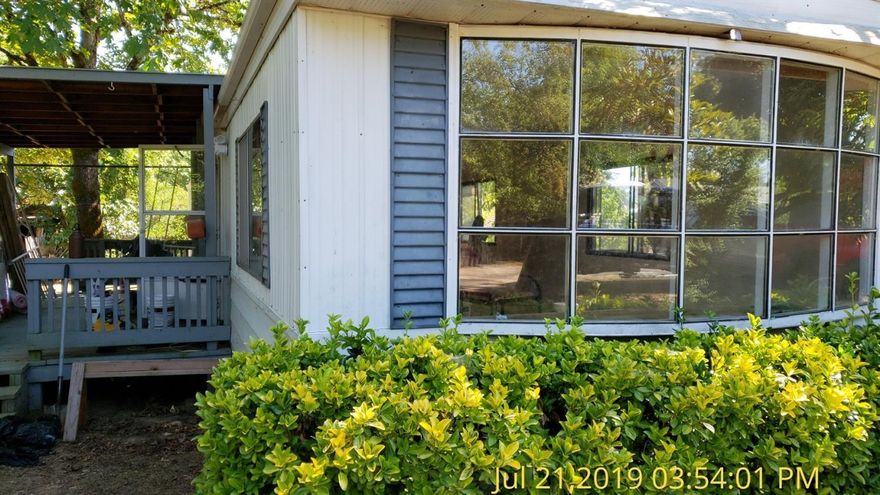 Totally refurbished and ready to move right in. New paint throughout, new flooring, new counter tops. Open and airy 2 bedrooms and 1 bath, washer and dryer hookups all on .21 of an acre.Kitchen comes with a refridgerator, dishwasher and range/oven combo. This is a must see to appreciate. Master bedroom has the back wall as vinyl windows accross and a mirrored wardrobe. A deck off the back door and another one off the livingroom, kitchen area.