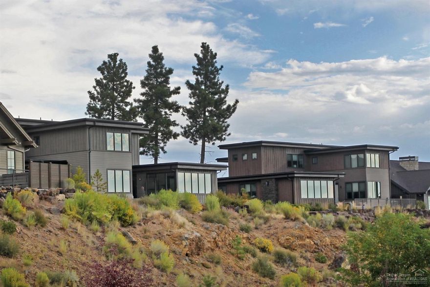 Perfectly situated near the resort's amenities and some of the best trails in Central OR, these income-producing vacation homes at Cairn allow you to take advantage of the Tetherow lifestyle. Wherever your travels take you, Cairn allows you to begin any adventure without venturing far. A typical day here includes a morning latte at the cafe, a swim and soak at Tetherow Sport, a round of golf, or a quick bike ride to Phil's Trail. When the day's over, head to The Row or Solomon's for a sunset dinner with Cascade views. This new Highlands Ridge floorplan is a fully turn-key 3,195 Sq Ft home w/ attached 2 car garage that features 5 Suites, modern and stylish finishes, a fire pit perfect for s'mores & memory making, rear courtyard, hot tub, and spectacular golf & mountain views. Not all inventory is actively listed in the MLS. Contact an agent to learn what else is available w/these income producing homes or to learn more! Photos of similar floor plan.