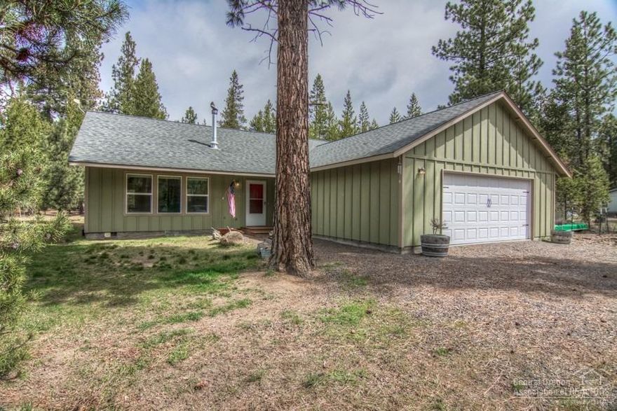 Priced to Sell and it shines! On a .99 acre fenced and gated parcel, with mature trees, paver patio and firepit to enjoy those summer evenings. Inside, nice laminate wood flooring, certified woodstove and a forced air furnace. This home is light and bright with good storage, large laundry/mud room, and finished garage. So close to Mountain Lakes and Forest for boating, hiking, biking, fishing, and winter sports!