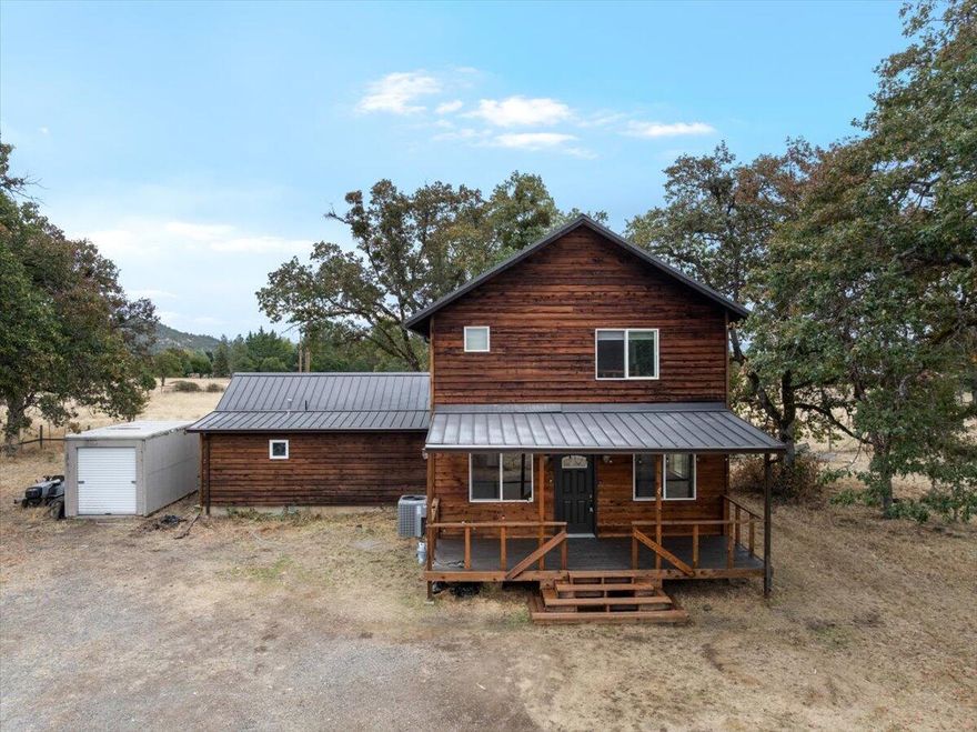 Welcome to your private slice of country living in beautiful Sams Valley! Nestled on 5 usable acres along the desirable Dodge Road, this 3-bedroom, 2-bathroom home includes a spacious dedicated office—perfect for working from home or creative pursuits. Cedar siding and a generous front porch offer timeless curb appeal, while inside you'll find warm rustic touches like a log staircase centerpiece, fir paneling lined skylight and an oversized primary suite with plenty of room to unwind. The land is ready for your rural dreams with raised garden beds, room to roam, space for horses or livestock, and an old shop building waiting for its next chapter. Whether you're looking to homestead, spread out, or simply enjoy the peace of the valley, this property offers the freedom and flexibility to make it your own.