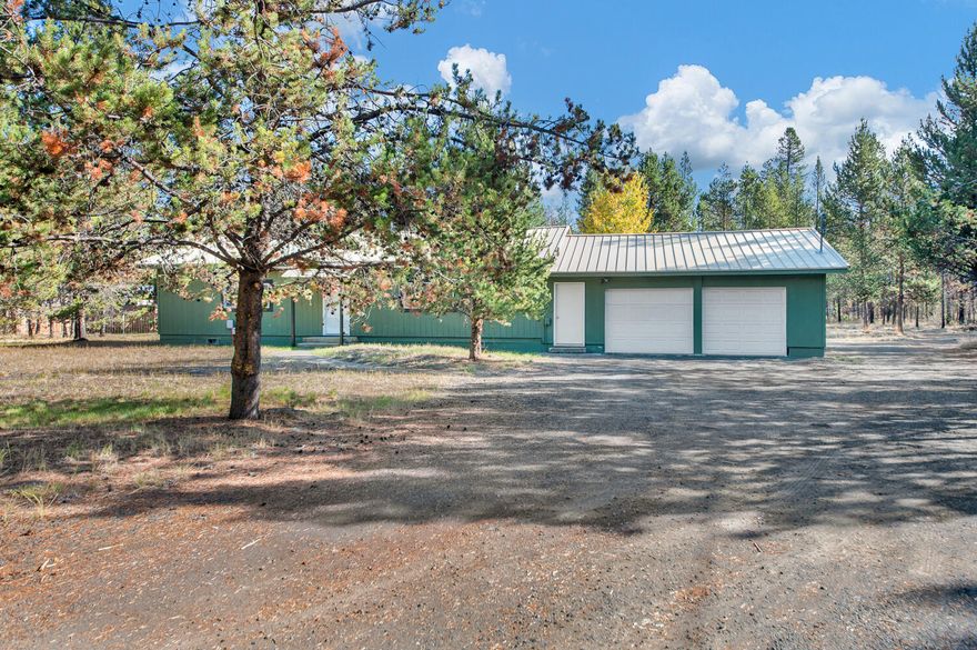 Amazing opportunity for under 300k! Stick built home with extra garage + a studio on over an acre in great condition. Fresh paint and spotless! 
This home has 2 bedrooms + den that can easily be utilized as 3rd bedroom. Features hardwood floors, updated bathroom, oversized garage w/workshop + another separate detached garage perfect for additional workshop or toy storage! New carpeting in bedrooms set to be installed and is prepaid. There is a super convenient breezeway between the garage and home that functions as storage/ laundry room and could easily be finished out for additional living space. Head out to the backyard to find the 2 room studio with full electricity - the ideal spot to have an exercise room, office, art studio or whatever you might need! New windows and front door in 2014. Partially fenced for dog. This neighborhood is part of future & free city water and sewer change over. See attached more info! Quick and convenient location to town and hwy but incredibly private.