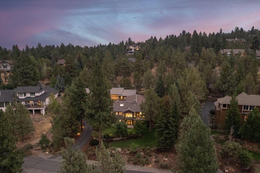 Perched directly above the scenic Deschutes River canyon, this home is tucked away on a tree lined street in desirable Wyndemere. Imagine starting each day on the river trail to breathtaking views of the sun hitting the canyon walls and lighting up the Cascade Mountains. Your private neighborhood access to the 12 mile Deschutes River Trail is right across the street! It gets better...Black Butte, Jefferson, Washington, and Mt. Hood are all perfectly framed throughout the main level of this tastefully remodeled home. Featuring an open layout, main level master suite, and no shortage of entertaining space or storage. 990 sf detached RV garage is 45' x 22' with 12' doors- perfect for a Sprinter van and toys. Plus an oversized 3 car garage and covered carport.