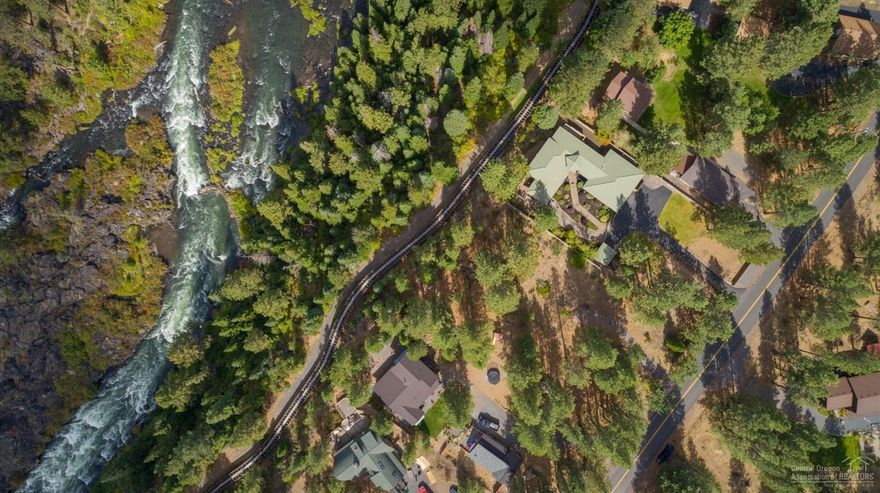 Relax to the sound of the rushing Deschutes river on this private .43 acre lot. Views of ponderosa, fir and lush river front foliage add to this mountain retreat. Peek-a-boo views of Mt Bachelor and the Deschutes River, with the Arnold Irrigation flume easement through back of property. This property borders forest land with Deschutes River frontage. See video for bird's eye view. Paved road.